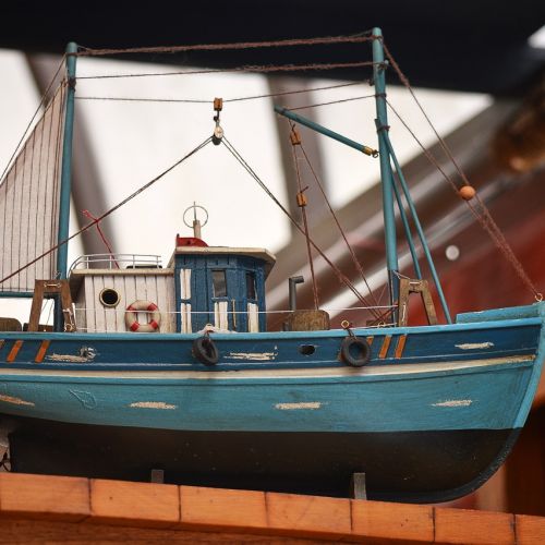 Why is painting important in creating a realistic model ship?